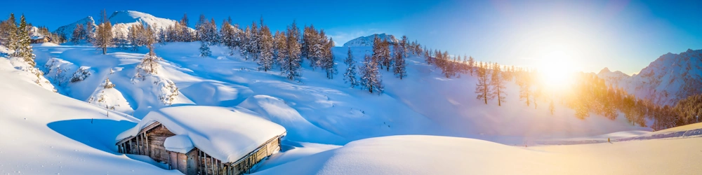 Snow-covered cabin in the mountains