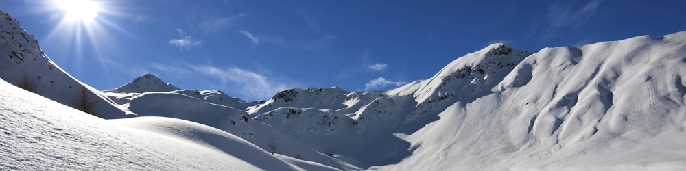 Mountains covered in powder snow in brilliant sunshine